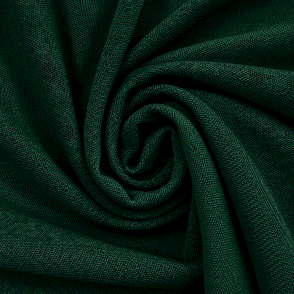 Close-up of dark green pique knit polo fabric showing texture, weave detail and premium finish.